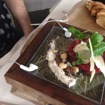 Hotel LA' di Moret - The Steak tartare comes served atop a glass box of hay.  The headphones play the sounds of cowbells and mooing. - Hotels Near Me - Udine, UD