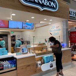a woman standing in front of a counter a woman standing in front of a counter