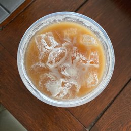 a drink in a plastic cup on a wooden table a drink in a plastic cup on a wooden table