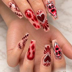 Collins Nails Salon & Spa - Spooky-chic Halloween nails featuring blood-red marble, stitched details, haunting ghosts, and gothic hearts on a glossy nude base.
