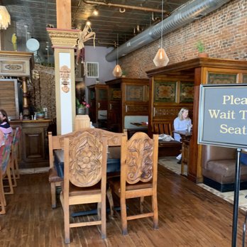 Cafe Cusco - Enclosed booths and open tables in an old space of wood and brick. - Peruvian Near Me - Springfield, Missouri Cafe Cusco - Enclosed booths and open tables in an old space of wood and brick. - Peruvian Near Me - Springfield, Missouri
