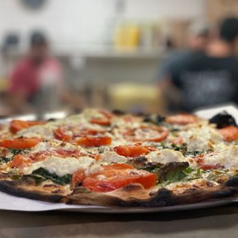 Fuoco Apizza - a close up of a pizza - Pizza Near Me - Cheshire, Connecticut