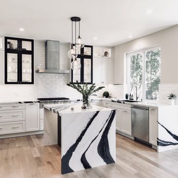 JC Building America - a kitchen with a marble island - General Contractors Near Me JC Building America - a kitchen with a marble island - General Contractors Near Me