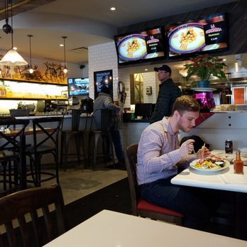 La Shawarma - a man eating at a restaurant - Middle Eastern Near Me - Bolton, Ontario La Shawarma - a man eating at a restaurant - Middle Eastern Near Me - Bolton, Ontario