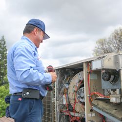 Lee’s Air, Plumbing & Heating - Our HVAC service specialist servicing a residential HVAC package unit.