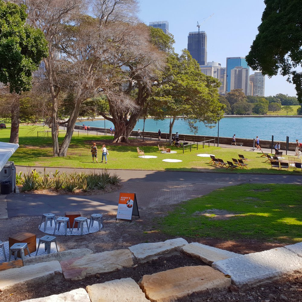 Busby's Bar - Views back across Farm Cove to the Royal Botanic Garden and the high-rise of the Sydney CBD. - Bars Near Me - Sydney, NSW Busby's Bar - Views back across Farm Cove to the Royal Botanic Garden and the high-rise of the Sydney CBD. - Bars Near Me - Sydney, NSW
