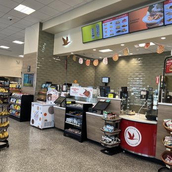 Wawa - the inside of a restaurant with a counter and food - Convenience Stores Near Me - Medley, Florida