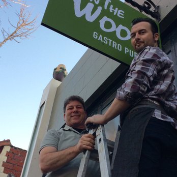 In The Wood - One of the owners Mike (left) hanging the sign on opening night. - Gastropubs Near Me - Berkeley, California
