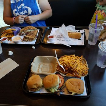 Urban Counter - a couple of people sitting at a table with trays of food - Hot Dogs Near Me - Wheaton, Illinois Urban Counter - a couple of people sitting at a table with trays of food - Hot Dogs Near Me - Wheaton, Illinois
