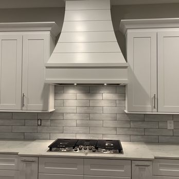 Prime Atlanta Renovations - a kitchen with white cabinets and a range hood - General Contractors Near Me Prime Atlanta Renovations - a kitchen with white cabinets and a range hood - General Contractors Near Me