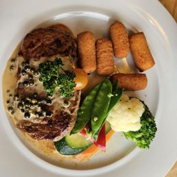 Ribeye steak with peppercorn sauce, potatoe crockets, and steam veggies Ribeye steak with peppercorn sauce, potatoe crockets, and steam veggies