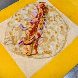 Juicy, flame-grilled chicken seekh kebab wrapped in fresh paratha with crisp vegetables and house-made sauces.