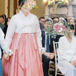Mothers of the bride and the groom walk down the aisle