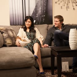 Ashley HomeStore - Customers testing out one of our many sectional sofas.