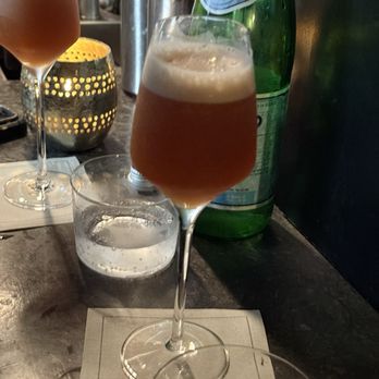 Cloakroom Bar - Charlie Chaplin amplified with sparkling wine, chamomile, aperol, and orange bitters. - Cocktail Bars Near Me - Montreal, Quebec