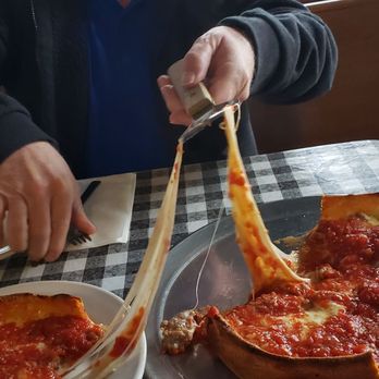 Bono's Pizzeria - a man eating a deep dish pizza - Pizza Near Me - Saint Louis, Missouri Bono's Pizzeria - a man eating a deep dish pizza - Pizza Near Me - Saint Louis, Missouri