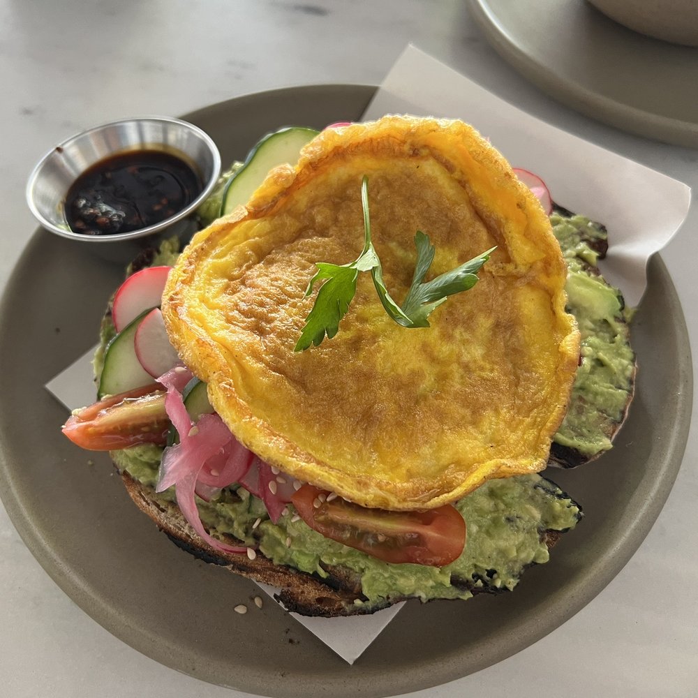 Macanela - Avocado Toast (normally egg is cooked sunny side up but we ordered it more scrambled/omelette style). Very good spicy sauce on side. - Juice Bars & Smoothies Near Me - Guanajuato, GUA Macanela - Avocado Toast (normally egg is cooked sunny side up but we ordered it more scrambled/omelette style). Very good spicy sauce on side. - Juice Bars & Smoothies Near Me - Guanajuato, GUA