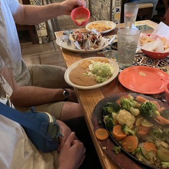 La Cantina - a man sitting at a table with plates of food - Mexican Near Me - Beaumont, Texas La Cantina - a man sitting at a table with plates of food - Mexican Near Me - Beaumont, Texas
