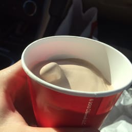 a hand holding a cup of hot chocolate