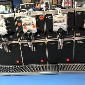 Donut Delite - a row of donuts on a machine - Donuts Near Me - Menlo Park, California