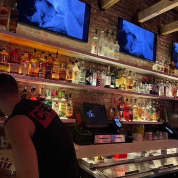 Rise Bar - a man sitting at the bar - Gay Bars Near Me - New York, New York Rise Bar - a man sitting at the bar - Gay Bars Near Me - New York, New York
