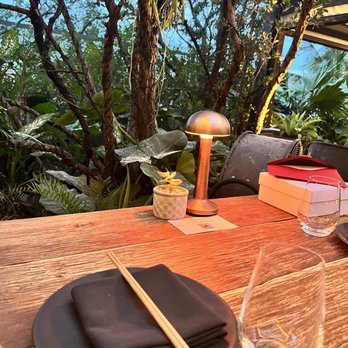 MILA Restaurant - Outside table by the garden - Mediterranean Near Me - Miami Beach, Florida MILA Restaurant - Outside table by the garden - Mediterranean Near Me - Miami Beach, Florida
