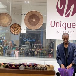 Uniquely Crafted - Uniquely Crafted very own employee Jabari and a Photo bomb of my Bestie mingling in the rack of clothes in the back