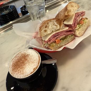 Parma Café - Cappuccino and charcuterie panini. - Italian Near Me - Montreal, Quebec Parma Café - Cappuccino and charcuterie panini. - Italian Near Me - Montreal, Quebec