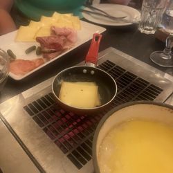 Les Fondus de la Raclette - This was the fondue and the cheese in a pan with the plate of charcuterie.