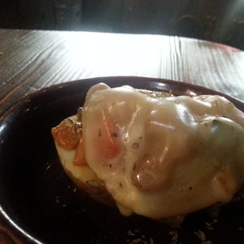 Old Wild West - The baked potato is 'new potato' (not russet) covered in vegetable ragu and cheese. - Burgers Near Me - Milan, Michigan