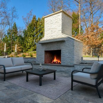 Phoenix Home Services - Silver Travertine Patio with Custom Stone Fireplace - General Contractors Near Me - Fairfax, Virginia