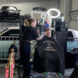 Christi cutting hair with Macklemore's Cadi in the background