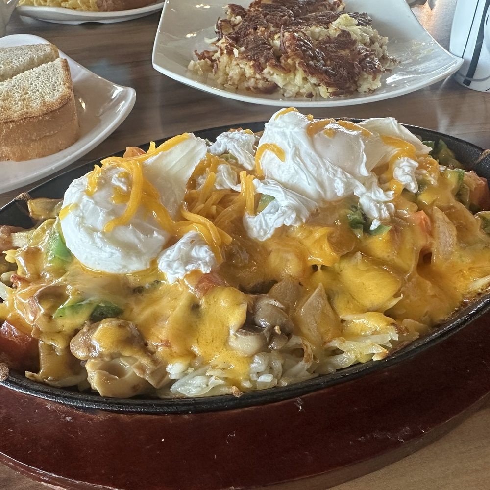 Cedar Park Cafe - Veggie skillet with poached eggs and cheddar, with a generous pile of hashbrowns on the side. - Breakfast & Brunch Near Me - Cedar Park, Texas