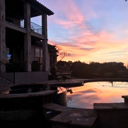 a sunset reflecting in a pool
