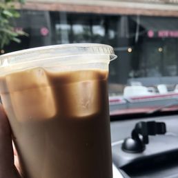 a hand holding a cup of coffee