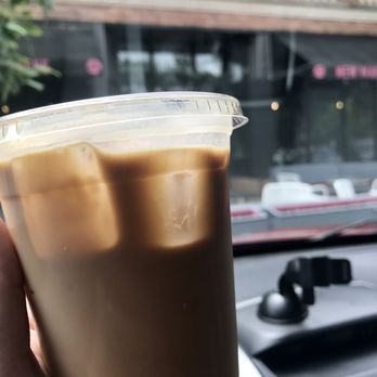 New Wave Coffee - a hand holding a cup of coffee - Coffee & Tea Near Me - Chicago, Illinois