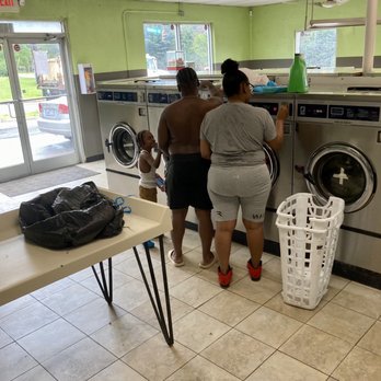 Super Coin Laundry - Young, black couple undresses (a bit) and unloads their two-bins full of laundry before leaving it to wash. - Laundromat Near Me - Winston-Salem, North Carolina Super Coin Laundry - Young, black couple undresses (a bit) and unloads their two-bins full of laundry before leaving it to wash. - Laundromat Near Me - Winston-Salem, North Carolina