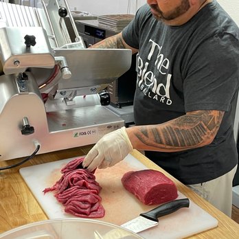 Jerky Jim's - a man slicing meat on a cutting board - Specialty Food Near Me - Wylie, Texas Jerky Jim's - a man slicing meat on a cutting board - Specialty Food Near Me - Wylie, Texas