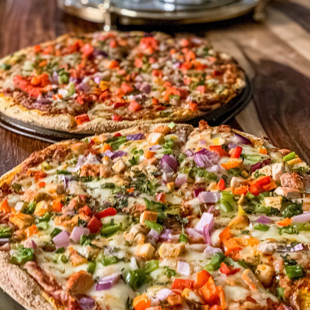 Chili Craft Pizza - two pizzas on a table - Indian Near Me - Nepean, Ontario