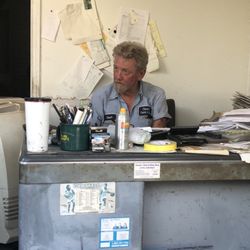 Claude's Paint & Body Shop - Claude at his desk.