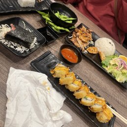 Golden cali roll , spam masubi, teriyaki chicken bento box with Golden California roll . Golden cali roll , spam masubi, teriyaki chicken bento box with Golden California roll .