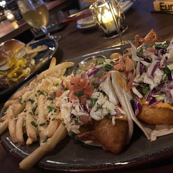 Eureka! - Double Smash Burger in the background & Baja Fish Tacos with Truffle Cheese Fries. - American Near Me - Aliso Viejo, California Eureka! - Double Smash Burger in the background & Baja Fish Tacos with Truffle Cheese Fries. - American Near Me - Aliso Viejo, California