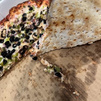 The Market At Hidden Meadows - Bottom of larger pie shows holes from dough aerator and more uniform crust edge. - Salad Near Me - Escondido, California The Market At Hidden Meadows - Bottom of larger pie shows holes from dough aerator and more uniform crust edge. - Salad Near Me - Escondido, California