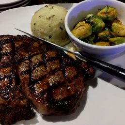 Ribeye steak with mash potato and brussel sprouts.