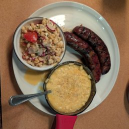 Smoked brisket kielbasa, cheesy creamed corn, corn and radish salad