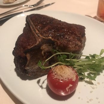 T-Bones - Thick porterhouse with a cherry tomato. Yes, a cherry tomato. - Steakhouses Near Me - Las Vegas, Nevada T-Bones - Thick porterhouse with a cherry tomato. Yes, a cherry tomato. - Steakhouses Near Me - Las Vegas, Nevada