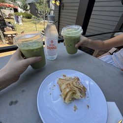 Two matcha lattes and an almond croissant