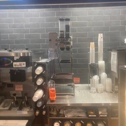 a counter with a coffee maker and a coffee machine