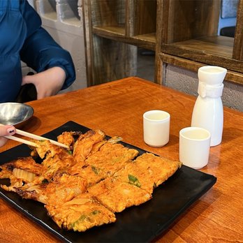 Naru Korean BBQ - a woman eating at a table - Korean Near Me - Clarksville, Tennessee