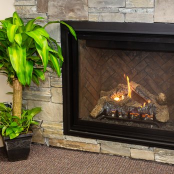 Grizzly Fireplace - a potted plant in front of a fireplace - Fireplace Services Near Me - Missoula, Montana